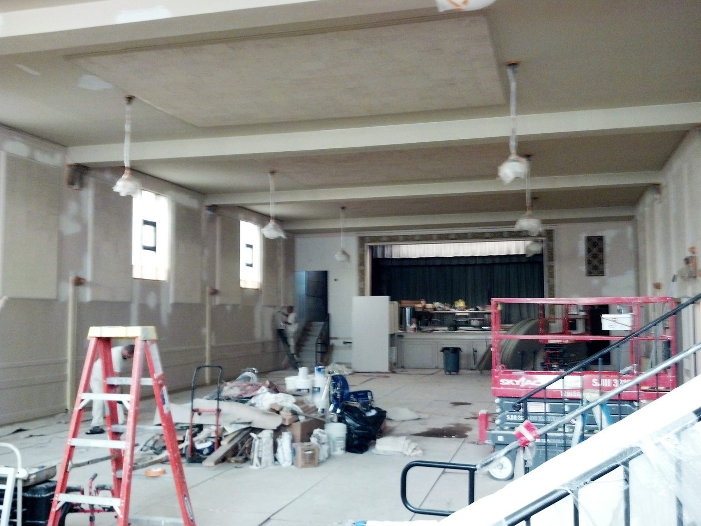 Large auditorium during surface preparation with scaffolding